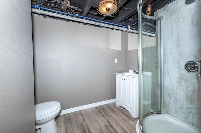 bathroom with hardwood / wood-style flooring, vanity, toilet, and an enclosed shower