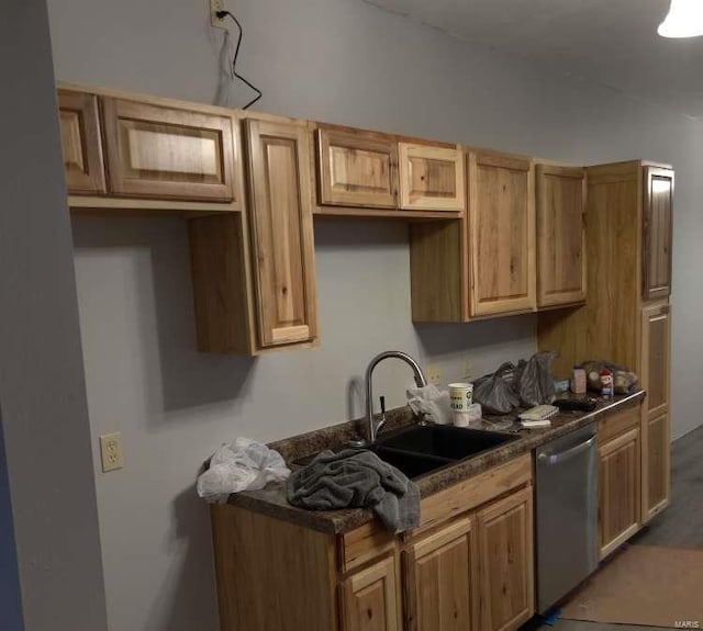 kitchen with dark wood-type flooring, stainless steel dishwasher, and sink