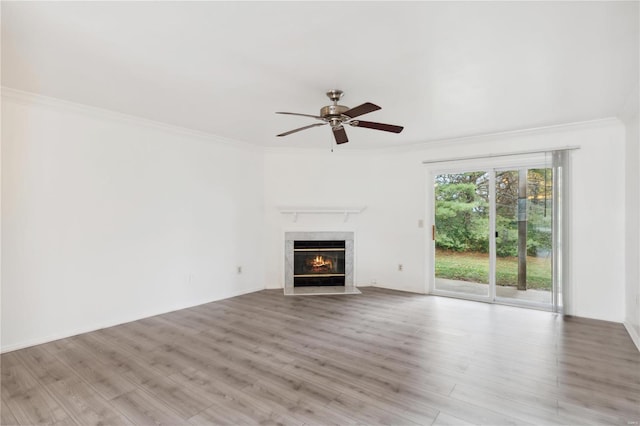 unfurnished living room featuring ceiling fan, light wood-type flooring, and crown molding