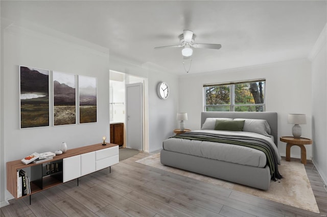 bedroom with light wood-type flooring, ceiling fan, and ornamental molding