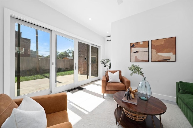 living room featuring an AC wall unit and light carpet