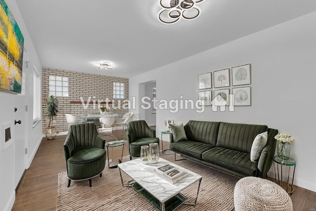 living room with hardwood / wood-style floors and brick wall