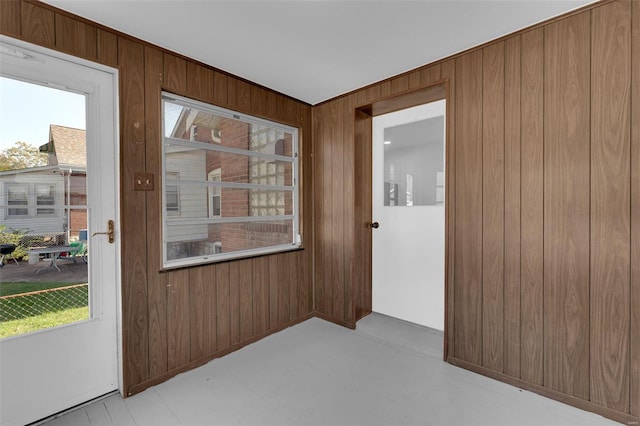 entryway featuring wood walls