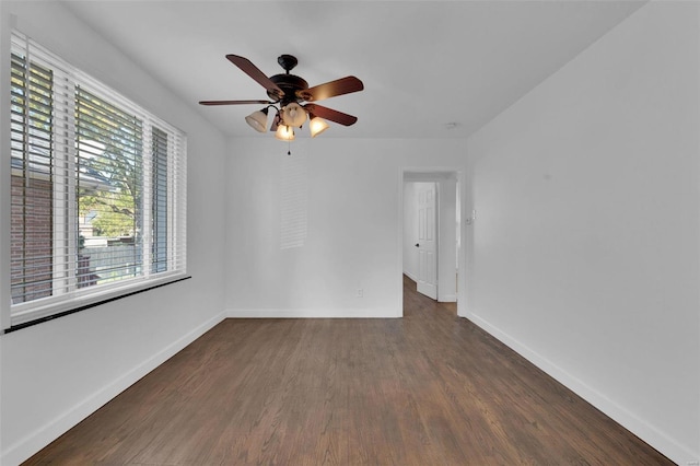 unfurnished room with ceiling fan and dark hardwood / wood-style flooring