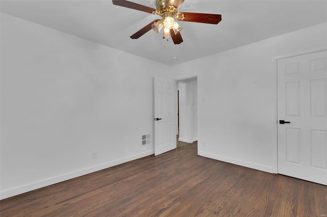 unfurnished room featuring ceiling fan and dark wood-type flooring