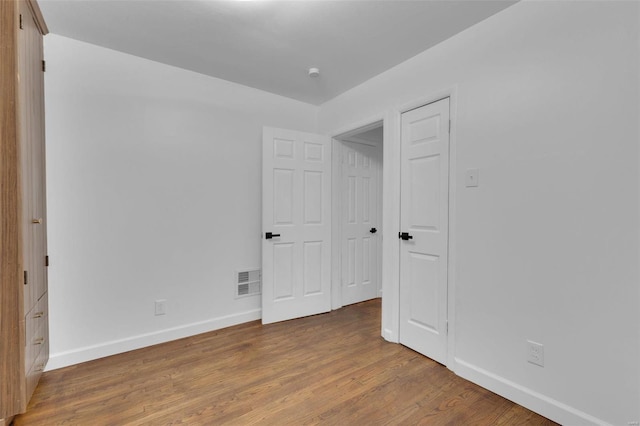 unfurnished bedroom featuring hardwood / wood-style floors