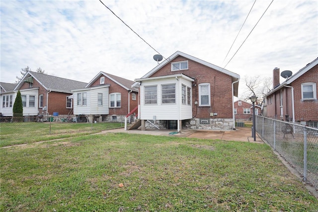 back of property with a lawn