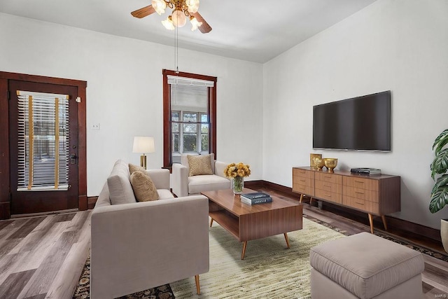 living room with ceiling fan and hardwood / wood-style floors