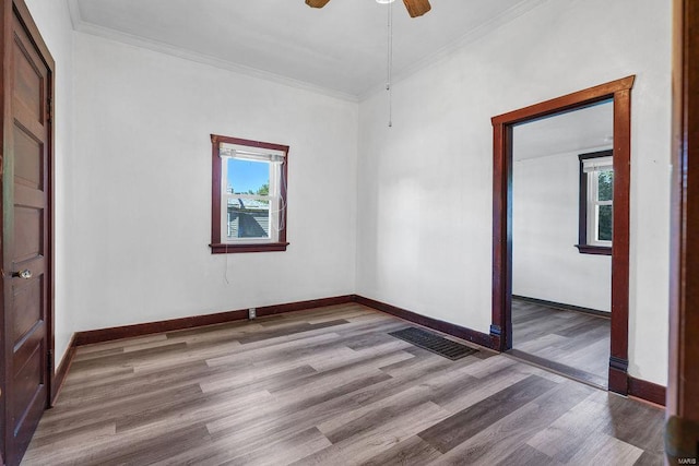 spare room featuring light hardwood / wood-style floors, plenty of natural light, and ceiling fan