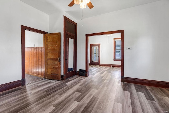 empty room featuring ceiling fan and hardwood / wood-style floors