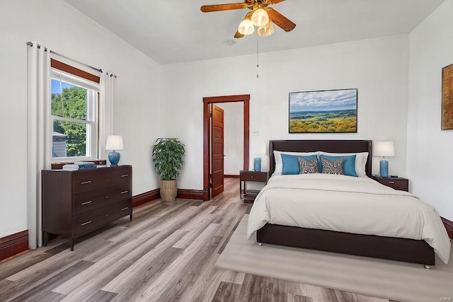 bedroom with light hardwood / wood-style flooring and ceiling fan