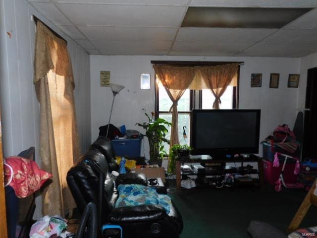 living room featuring a drop ceiling