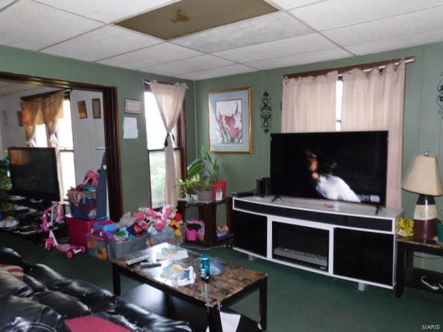 living room featuring a paneled ceiling