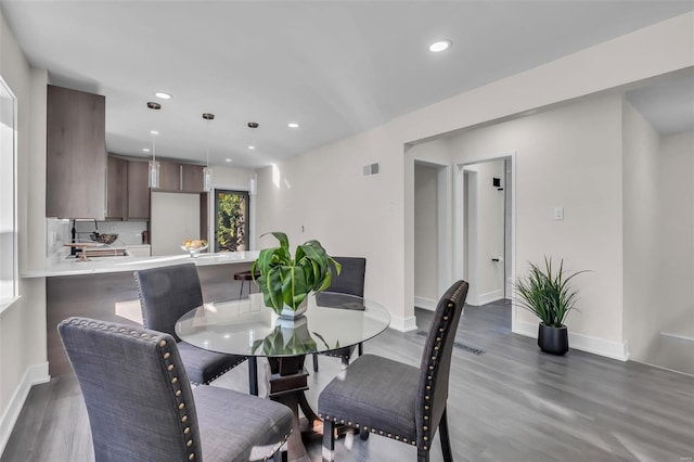 dining space with dark hardwood / wood-style floors