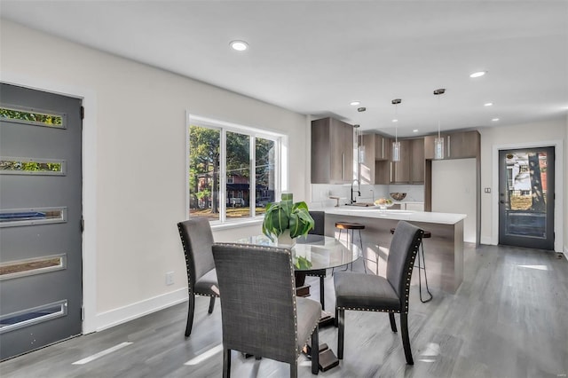 dining area featuring hardwood / wood-style floors and sink