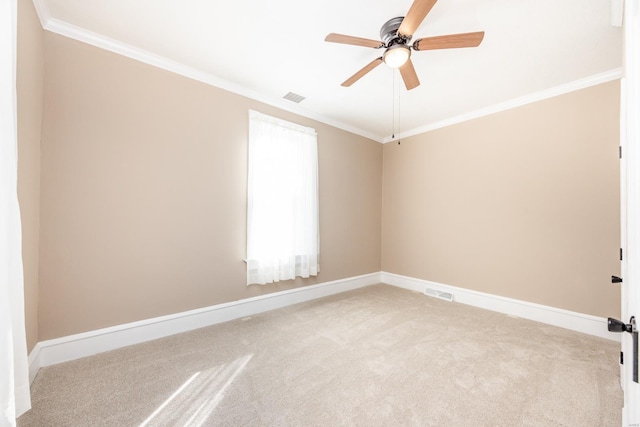 carpeted empty room with crown molding and ceiling fan