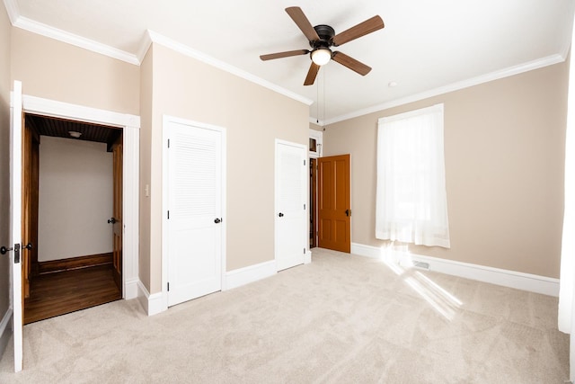 unfurnished bedroom with light carpet, ornamental molding, and ceiling fan