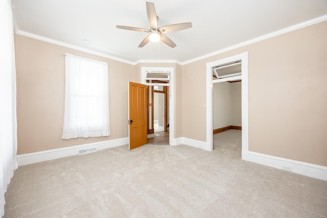 unfurnished bedroom featuring ornamental molding, ceiling fan, a closet, and light colored carpet