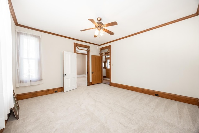 unfurnished bedroom featuring light carpet, crown molding, and ceiling fan