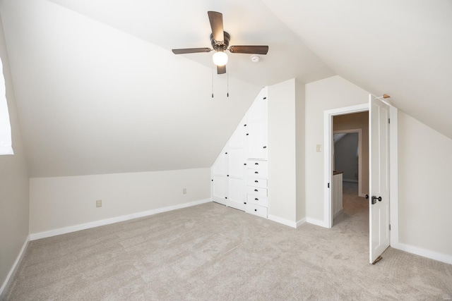 bonus room with light colored carpet, vaulted ceiling, and ceiling fan