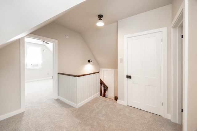 additional living space featuring lofted ceiling and light colored carpet