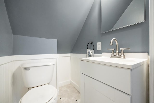 bathroom featuring vaulted ceiling, vanity, and toilet