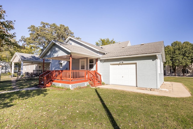 view of front facade featuring a garage, a front yard, and a wooden deck