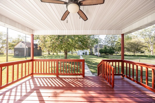 deck with a yard and ceiling fan