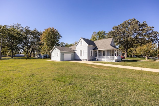 view of front of home featuring a front yard, a garage, and a porch