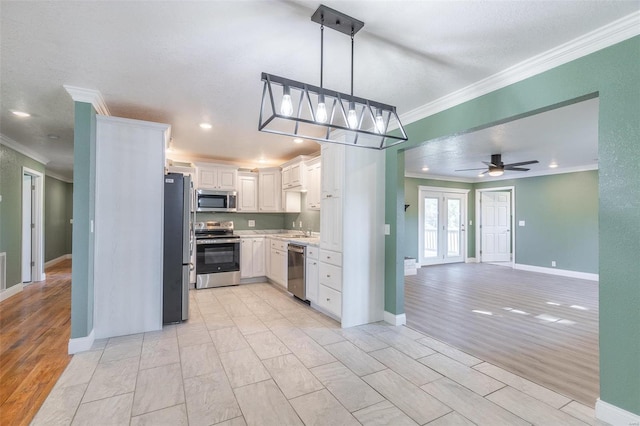 kitchen with ceiling fan, white cabinets, stainless steel appliances, and light hardwood / wood-style floors