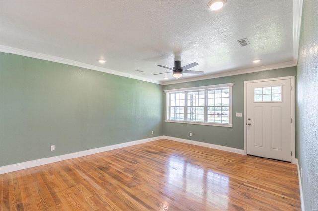 foyer with a textured ceiling, crown molding, ceiling fan, and light hardwood / wood-style flooring