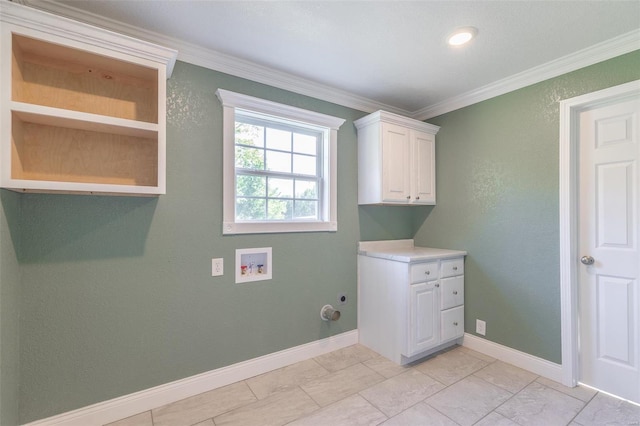 laundry area with washer hookup, cabinets, and crown molding