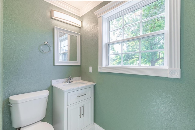 bathroom featuring ornamental molding, vanity, plenty of natural light, and toilet