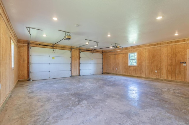 garage with wooden walls and a garage door opener