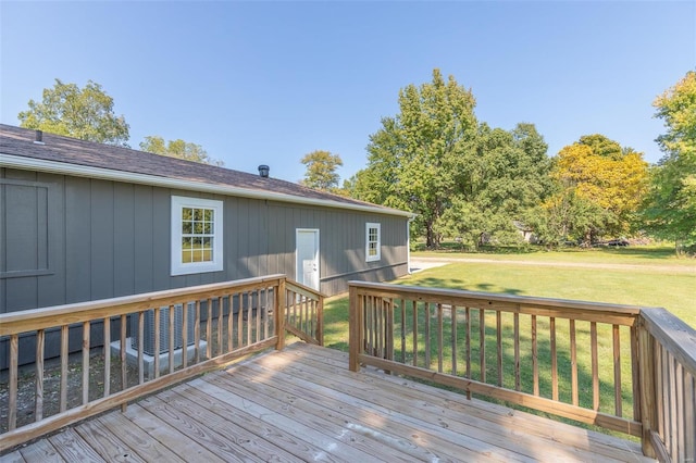 wooden deck featuring a yard