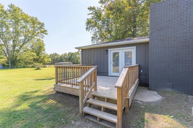 wooden terrace featuring french doors and a lawn