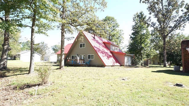 exterior space with cooling unit and a yard