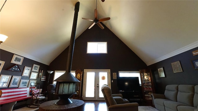 living room featuring high vaulted ceiling, a healthy amount of sunlight, and crown molding