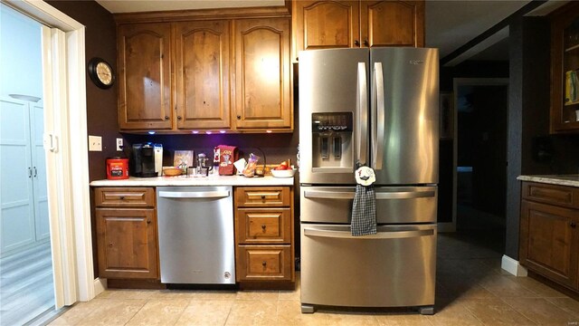 kitchen featuring light tile patterned floors and stainless steel appliances