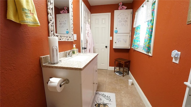 bathroom with tile patterned flooring and vanity