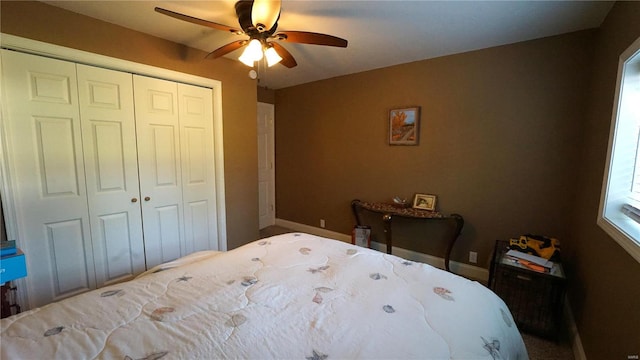 bedroom with ceiling fan and a closet