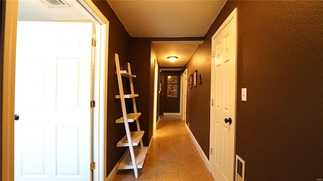 hall featuring light tile patterned flooring