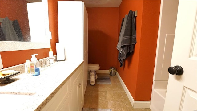 bathroom with tile patterned floors, vanity, and toilet