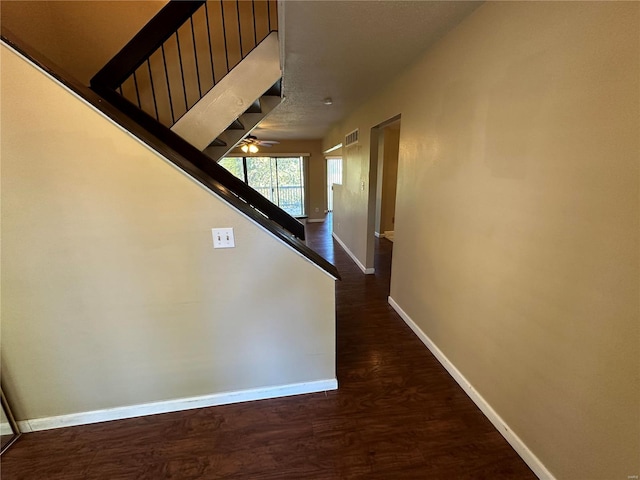 hallway with dark hardwood / wood-style flooring