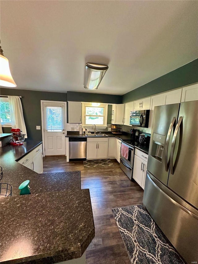 kitchen featuring white cabinetry, appliances with stainless steel finishes, plenty of natural light, and sink