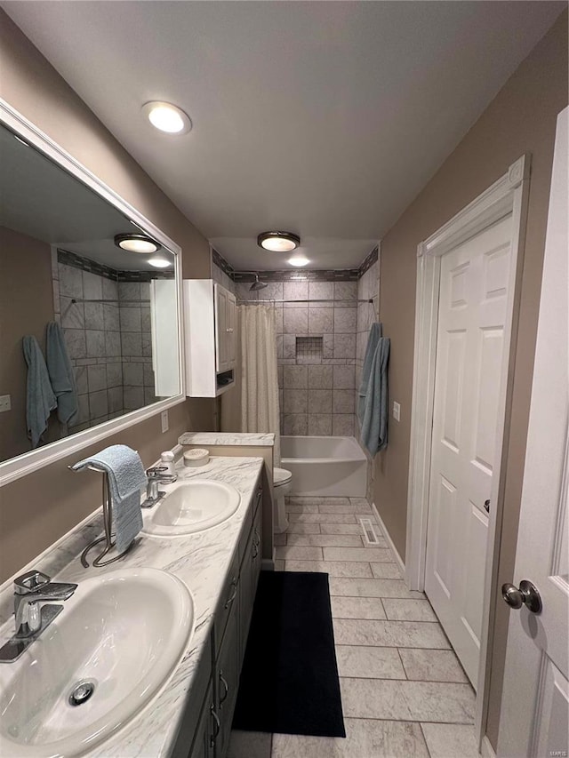 full bathroom with shower / tub combo, tile patterned flooring, vanity, and toilet