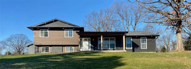 back of house with a lawn