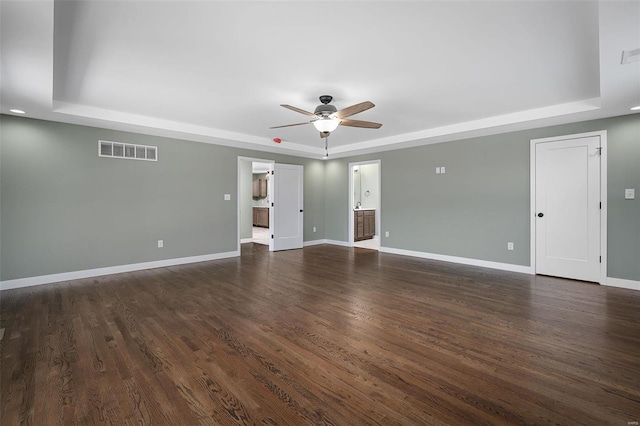 spare room featuring visible vents, baseboards, and a tray ceiling