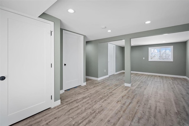 below grade area with recessed lighting, baseboards, and light wood-style floors