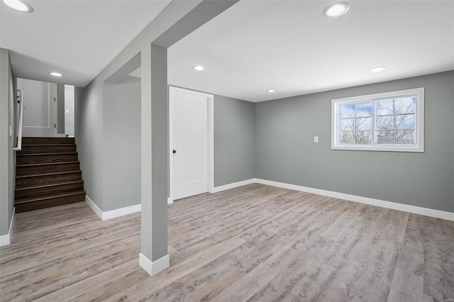 below grade area with recessed lighting, stairs, baseboards, and wood finished floors